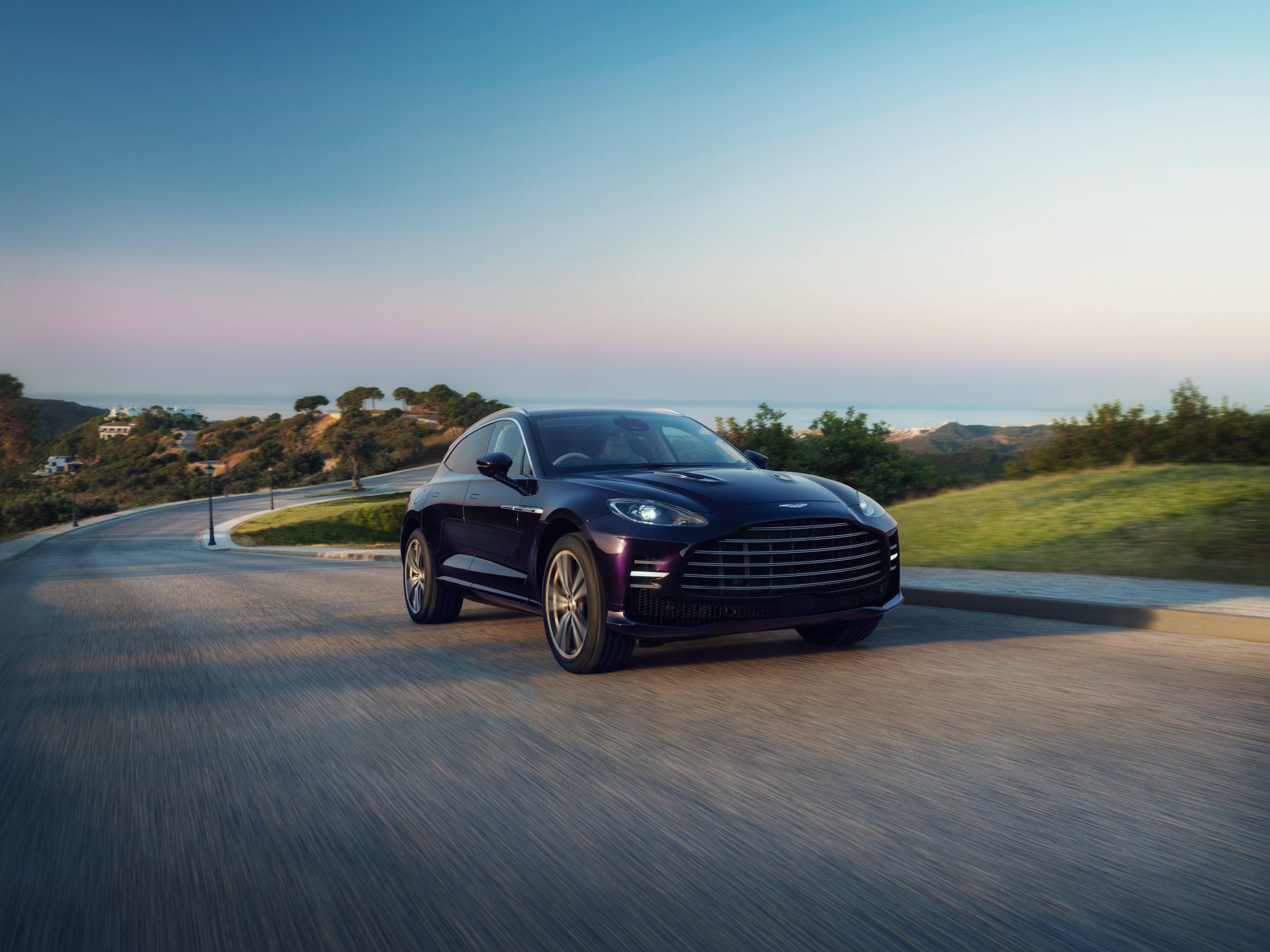 Aston Martin DBX GT circulando por una carretera de costa